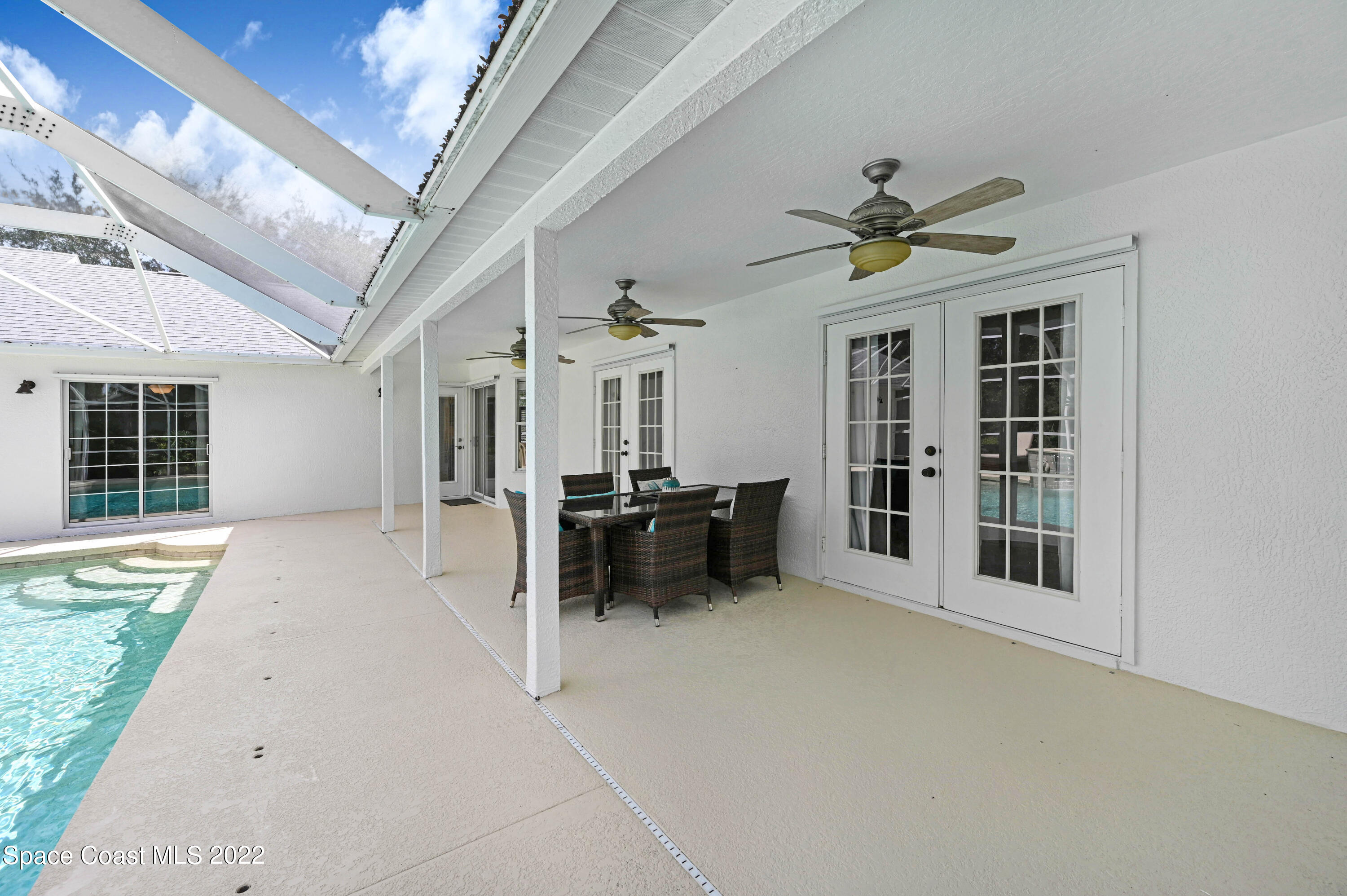3700 Big Pine Road Melbourne, FL 32934 - Photo 56 of 64 a view of a livingroom with furniture and a ceiling fan