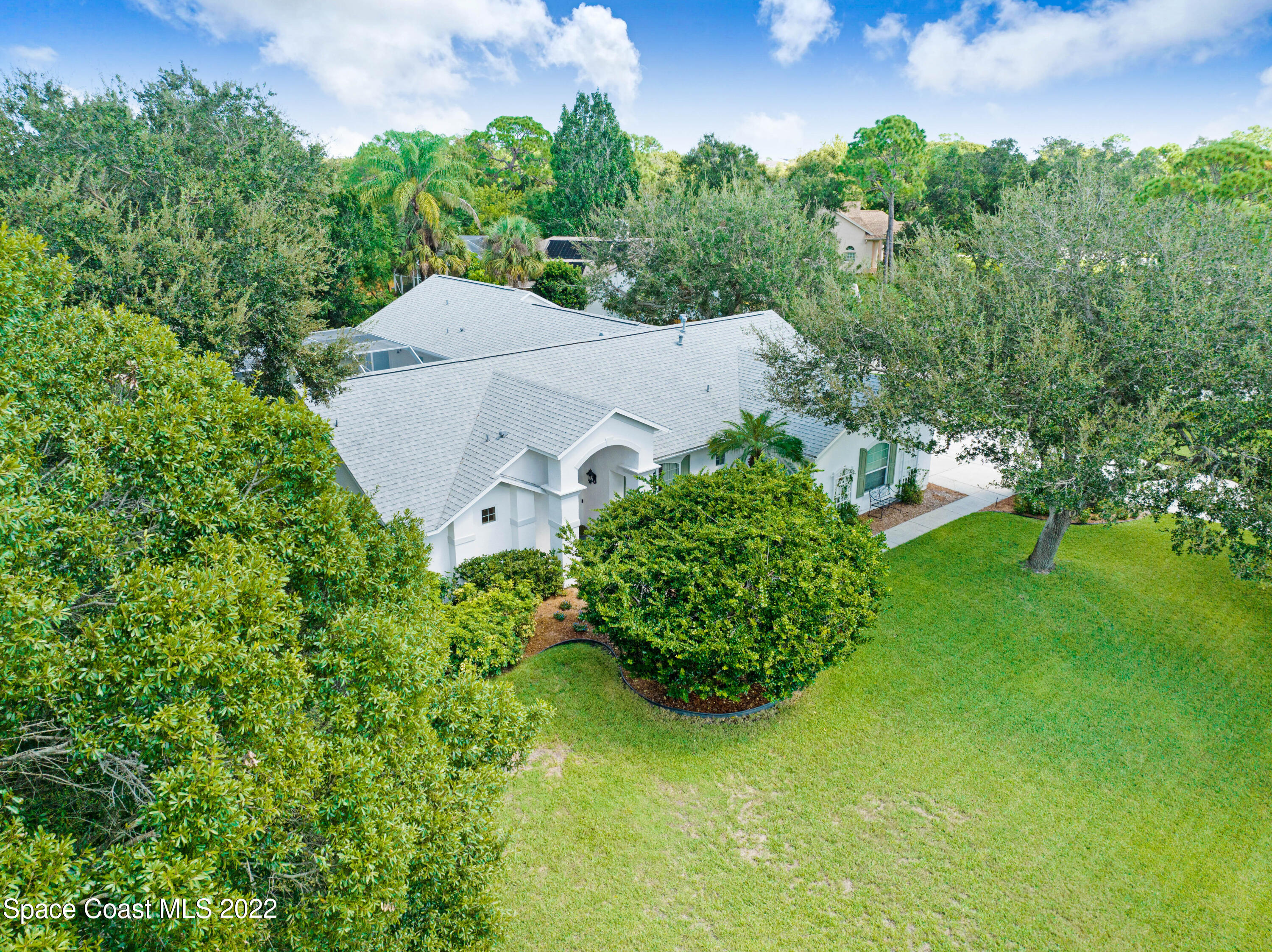 3700 Big Pine Road Melbourne, FL 32934 - Photo 62 of 64 an aerial view of a house with a yard and lake view