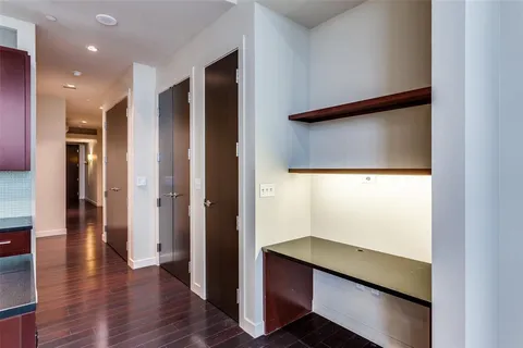 a view of hallway with wooden floor