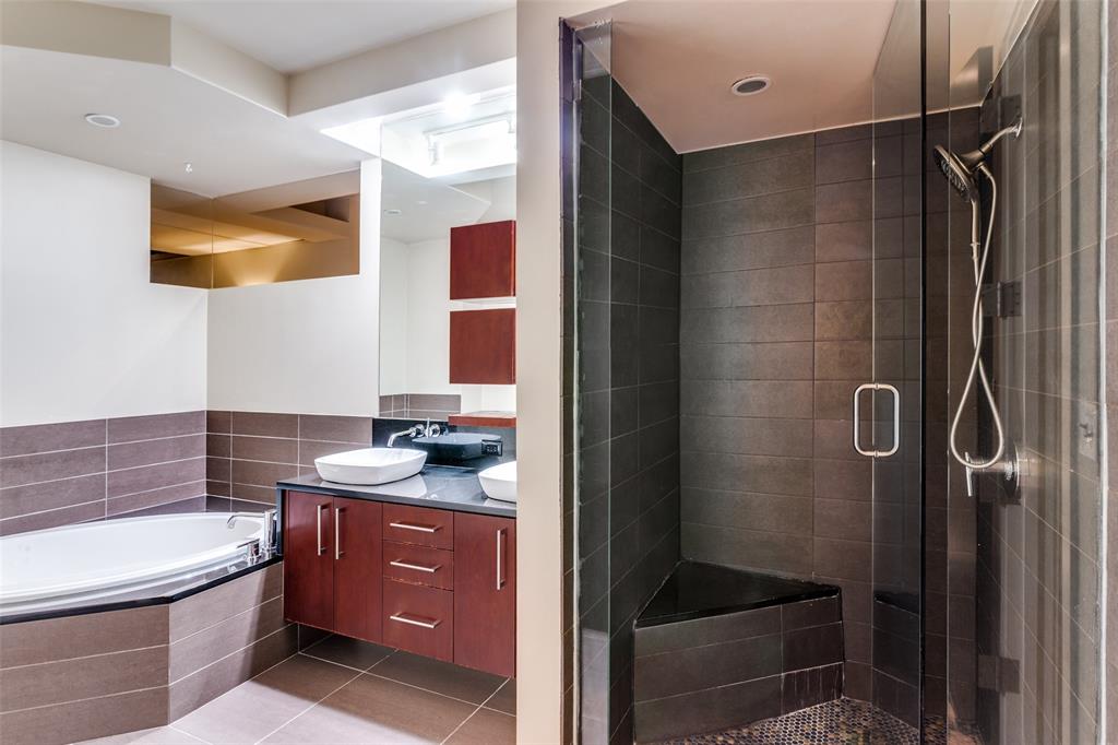 2600 West 7th Street, Unit 1311 Fort Worth, TX 76107 - Photo 17 of 25 a bathroom with a sink a toilet and shower