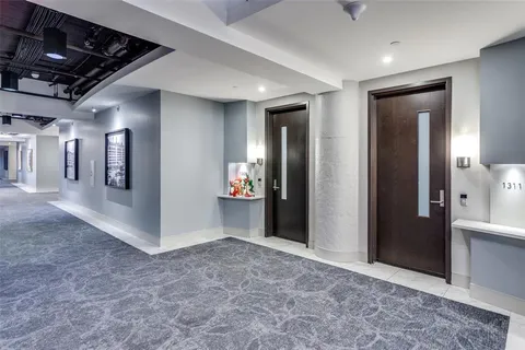 a view of a hallway with wooden shelves