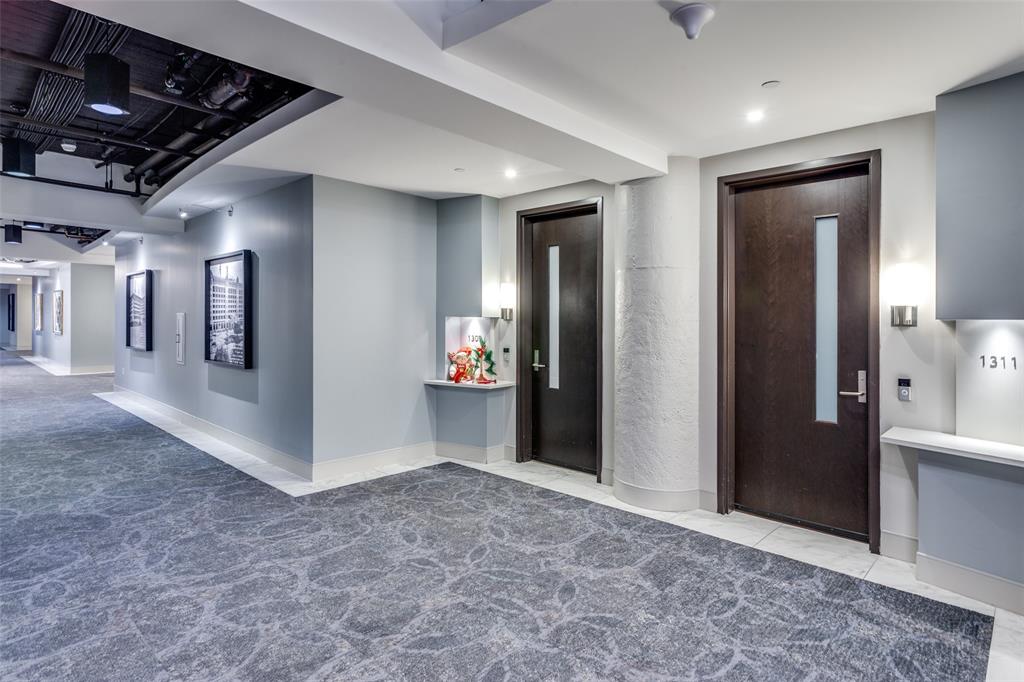 2600 West 7th Street, Unit 1311 Fort Worth, TX 76107 - Photo 2 of 25 a view of a hallway with wooden shelves