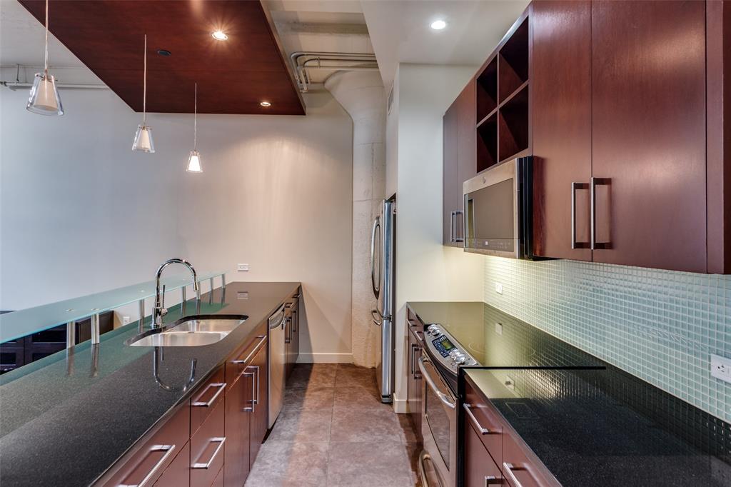 2600 West 7th Street, Unit 1311 Fort Worth, TX 76107 - Photo 6 of 25 a kitchen with stainless steel appliances a sink a stove and a refrigerator