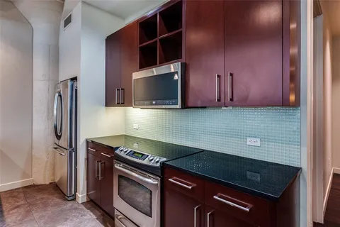 a view of a kitchen with stainless steel appliances cabinets and a counter top space