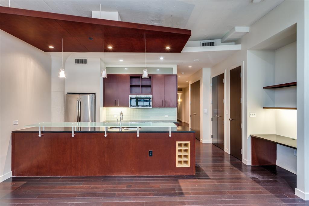 2600 West 7th Street, Unit 1311 Fort Worth, TX 76107 - Photo 9 of 25 a room with stainless steel appliances kitchen island granite countertop a stove a sink and a refrigerator