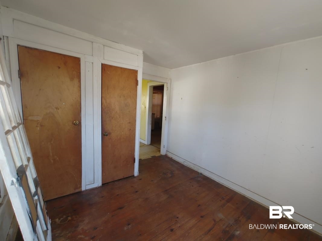 1706 Lomeroy Street Mobile, AL 36604 - Photo 17 of 24 Unfurnished bedroom with dark wood-type flooring
