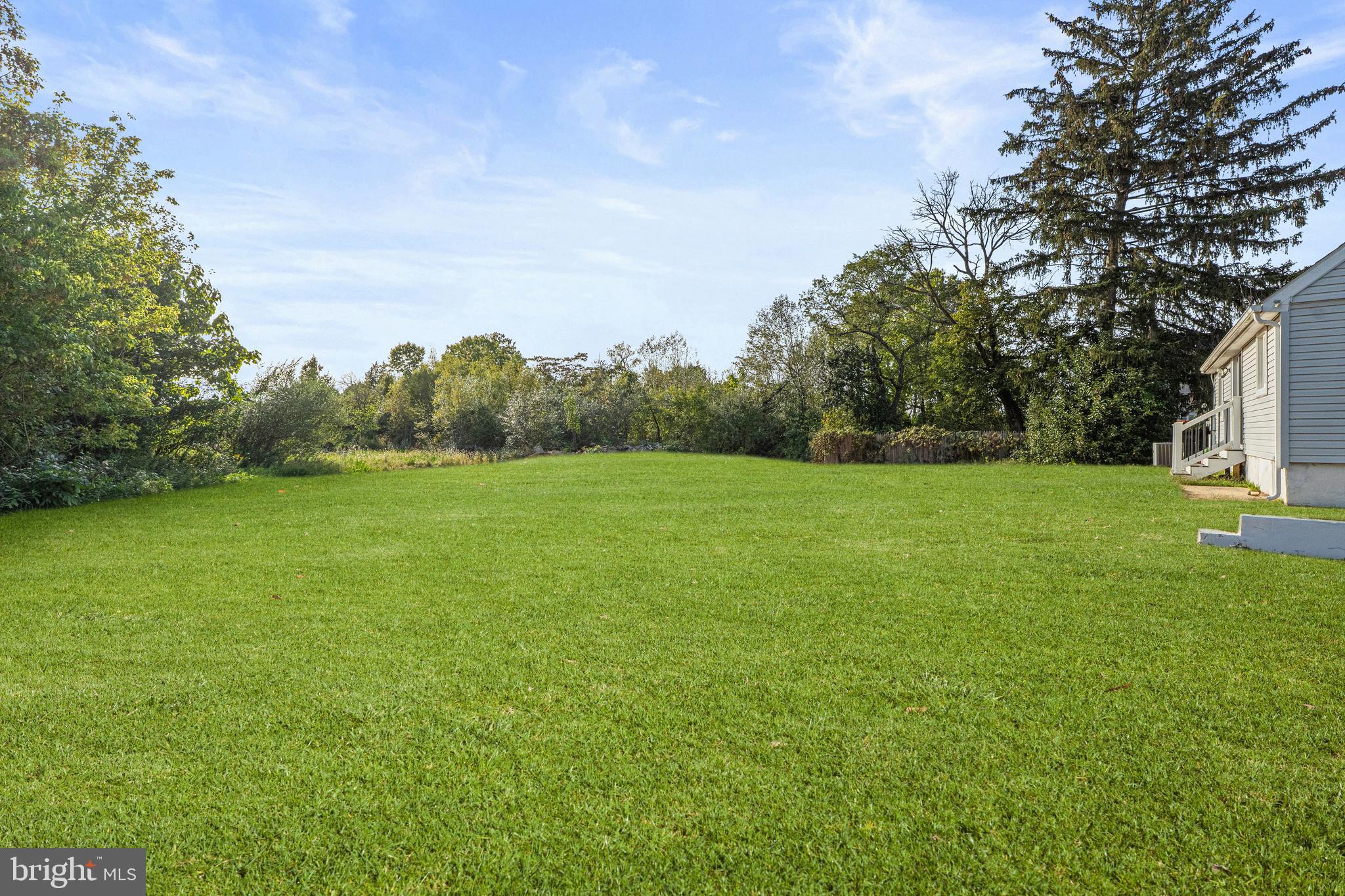 737 Watsontown Road Berlin, NJ 08009 - Photo 21 of 23 a view of a grassy field with trees in the background