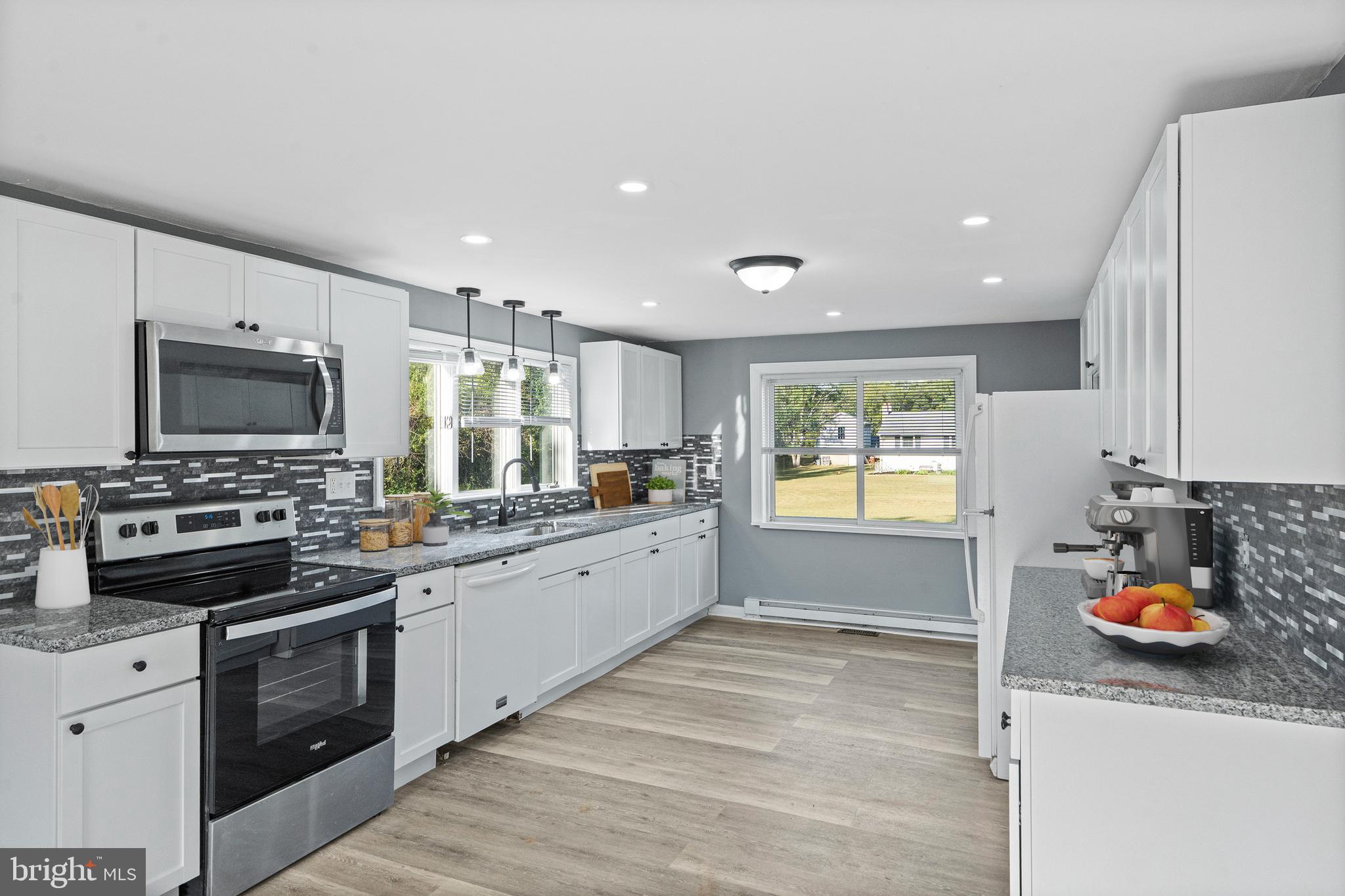 737 Watsontown Road Berlin, NJ 08009 - Photo 6 of 23 a kitchen with stainless steel appliances granite countertop a stove and a sink