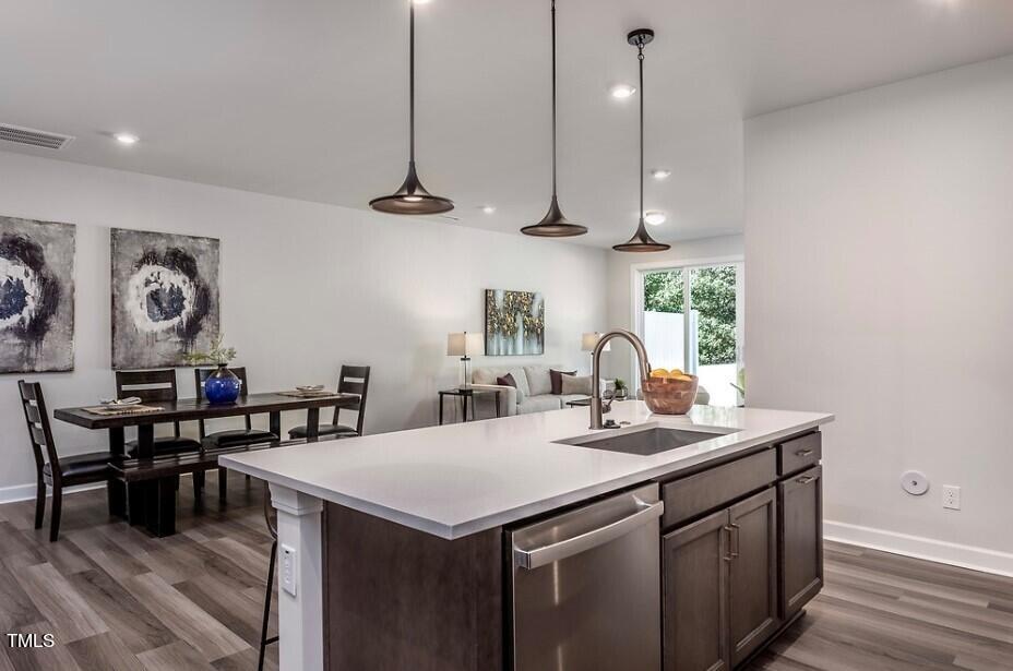 6103 Adecor Way Raleigh, NC 27617 - Photo 11 of 27 a kitchen with a sink a counter space appliances and cabinets
