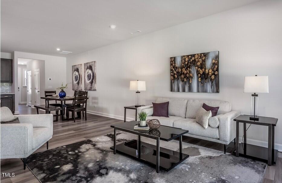 6103 Adecor Way Raleigh, NC 27617 - Photo 15 of 27 a living room with furniture and wooden floor