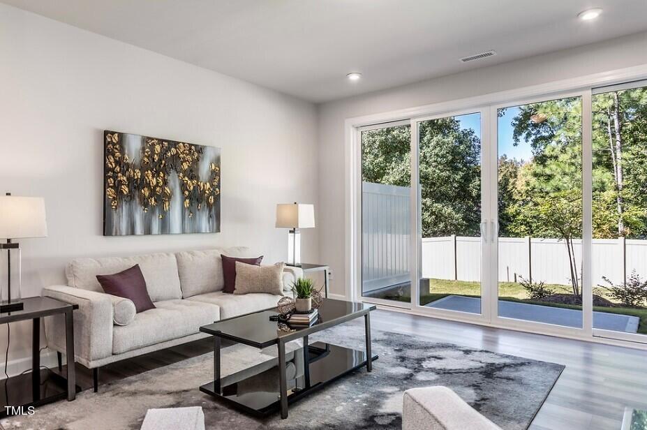 6103 Adecor Way Raleigh, NC 27617 - Photo 16 of 27 a living room with furniture and a large window