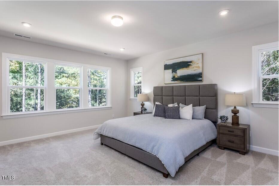 6103 Adecor Way Raleigh, NC 27617 - Photo 19 of 27 a bedroom with a large bed and a window