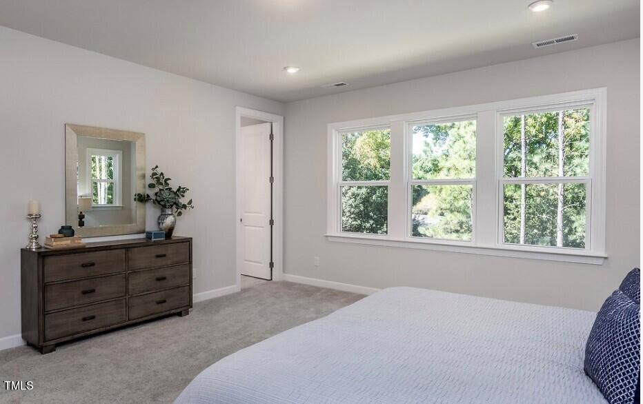 6103 Adecor Way Raleigh, NC 27617 - Photo 20 of 27 a spacious bedroom with a bed and a dresser