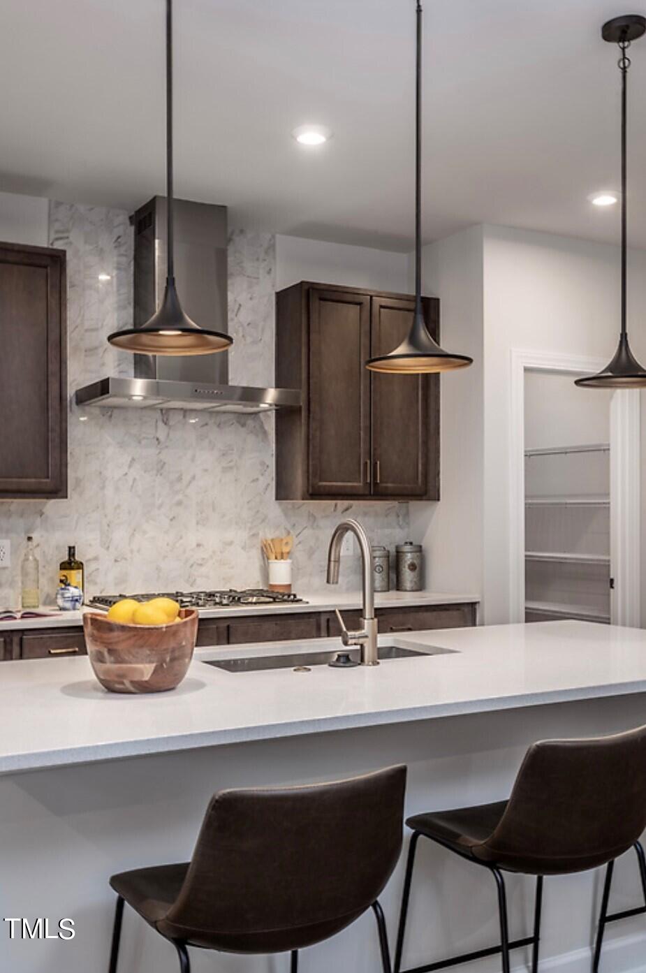6103 Adecor Way Raleigh, NC 27617 - Photo 9 of 27 a kitchen with stainless steel appliances a sink a table and chairs