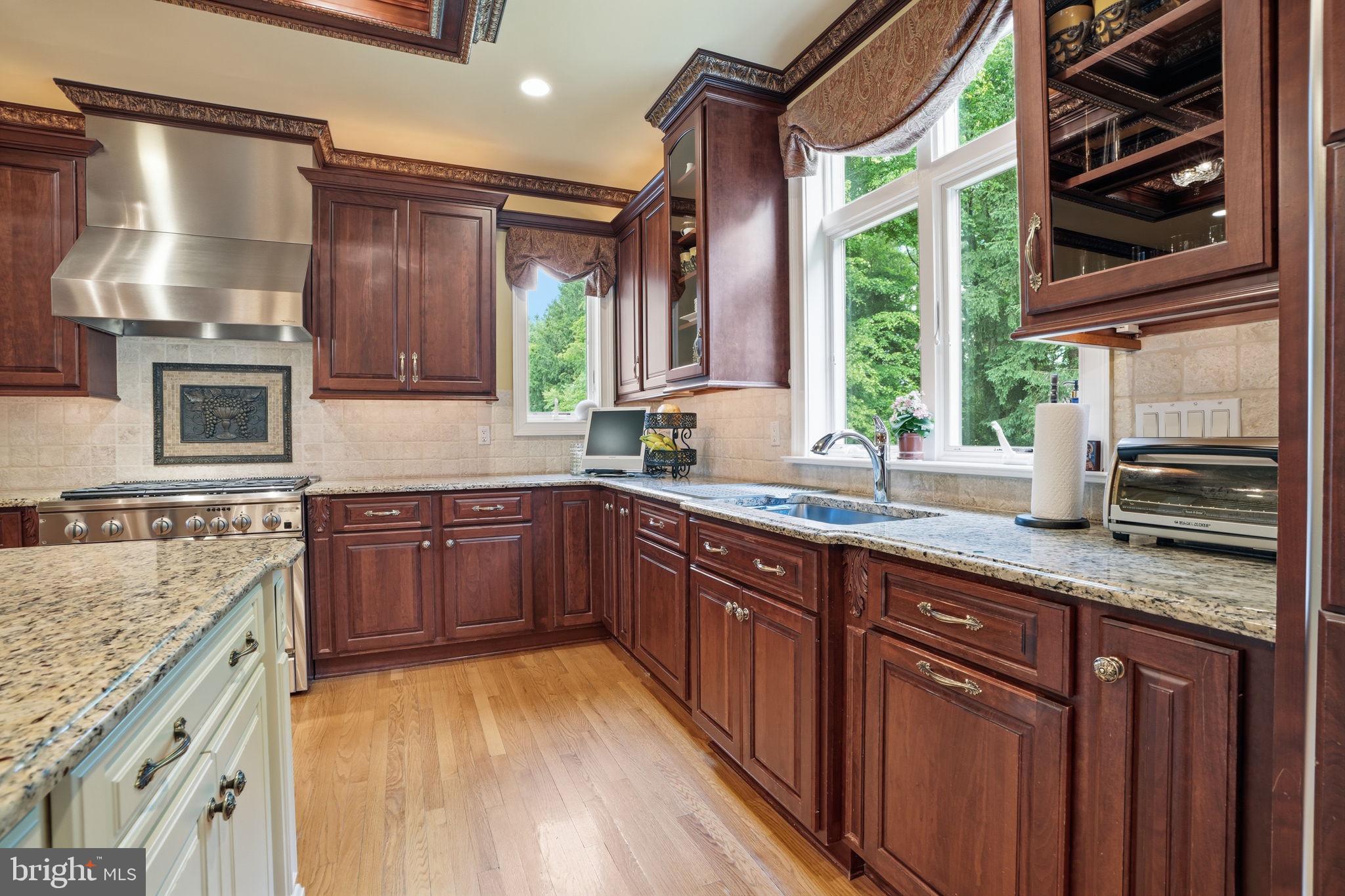 1588 Wrightstown Road Newtown, PA 18940 - Photo 27 of 81 a kitchen with stainless steel appliances granite countertop wooden cabinets a sink and a stove