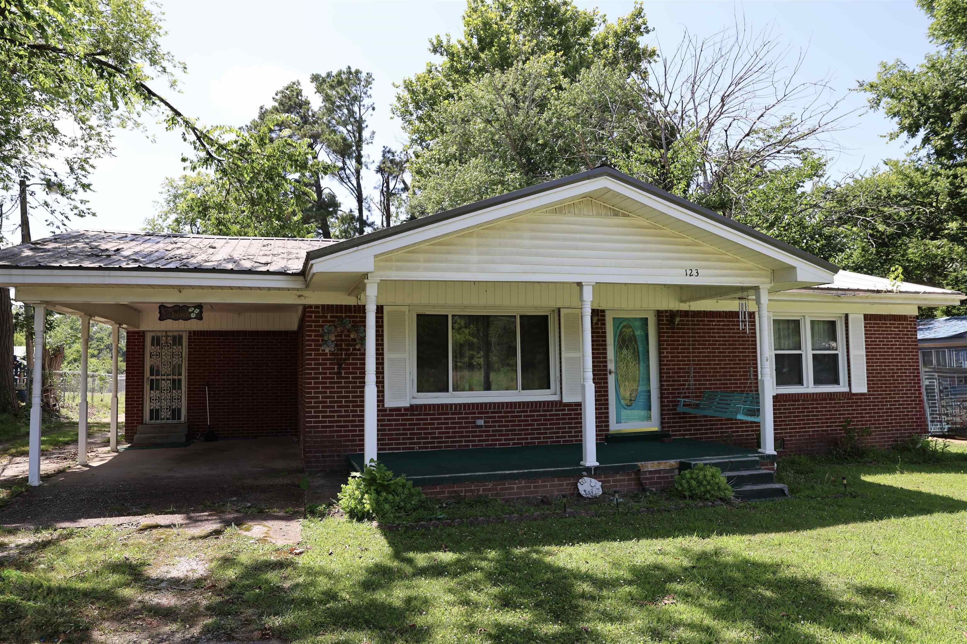123 North Magnolia Street Adamsville, TN 38310 - Photo 1 of 25 a view of a house with a yard and plants with large window