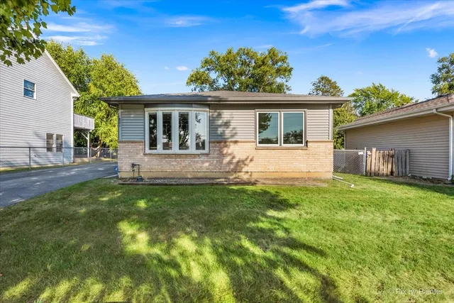 a front view of house with yard and outdoor seating