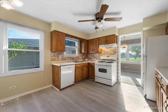 a kitchen with white cabinets and white appliances