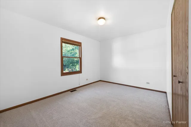 an empty room with closet area