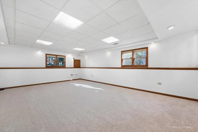 an empty room with a empty space and windows