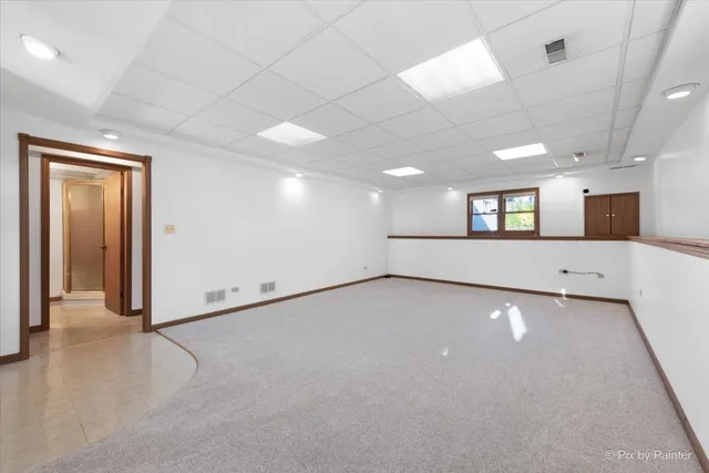 a big room with windows and kitchen