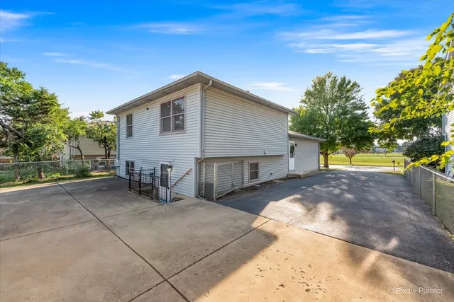 a view of a backyard with large trees