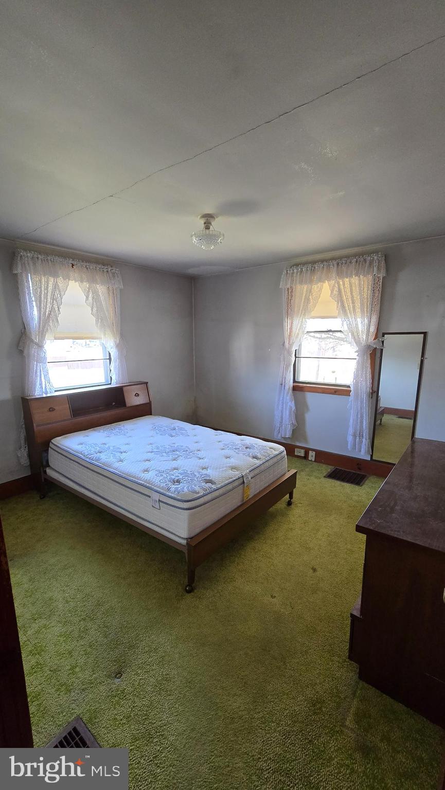1077 Paper Mill Road Chambersburg, PA 17202 - Photo 16 of 32 a bedroom with a bed table and window