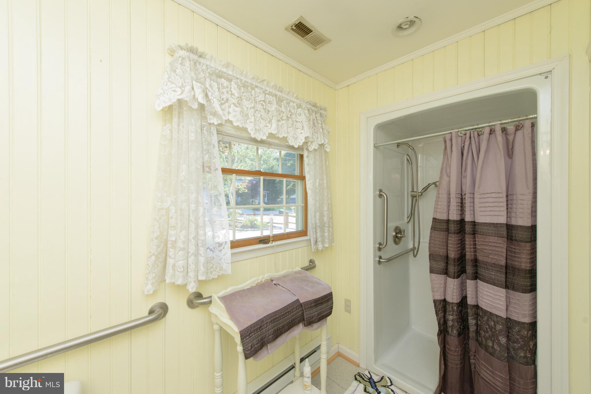 7860 West Riverside Drive Pasadena, MD 21122 - Photo 20 of 28 Shower with grab bars and Shower seat