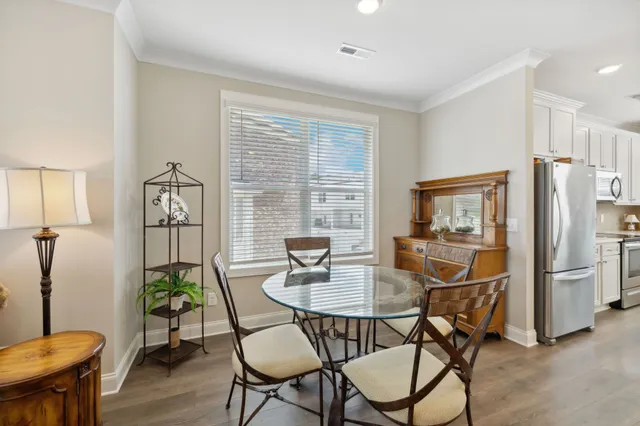 a dining room with furniture a window and wooden floor