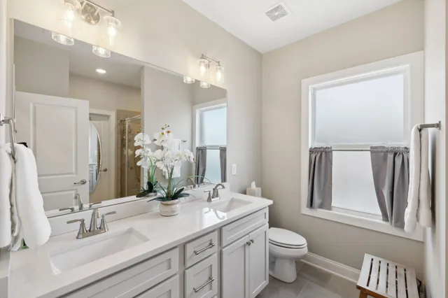 a bathroom with a double vanity sink and a mirror