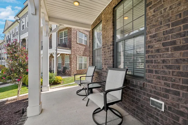 a view of a patio with table and chairs and potted plants