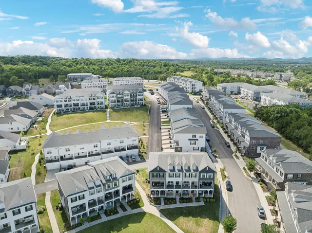 a view of swimming pool with outdoor seating and city view