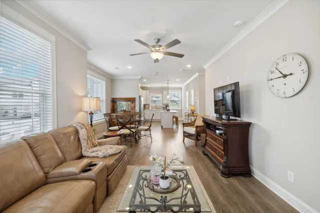 a living room with furniture a fireplace and a window