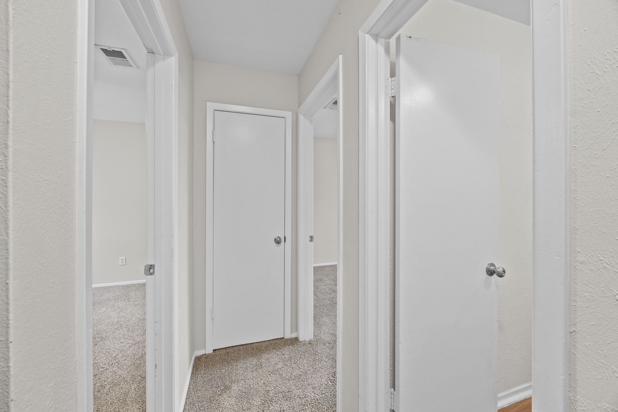 6904 Rifle Bend, Unit A Austin, TX 78736 - Photo 17 of 22 Corridor featuring light colored carpet and a textured wall