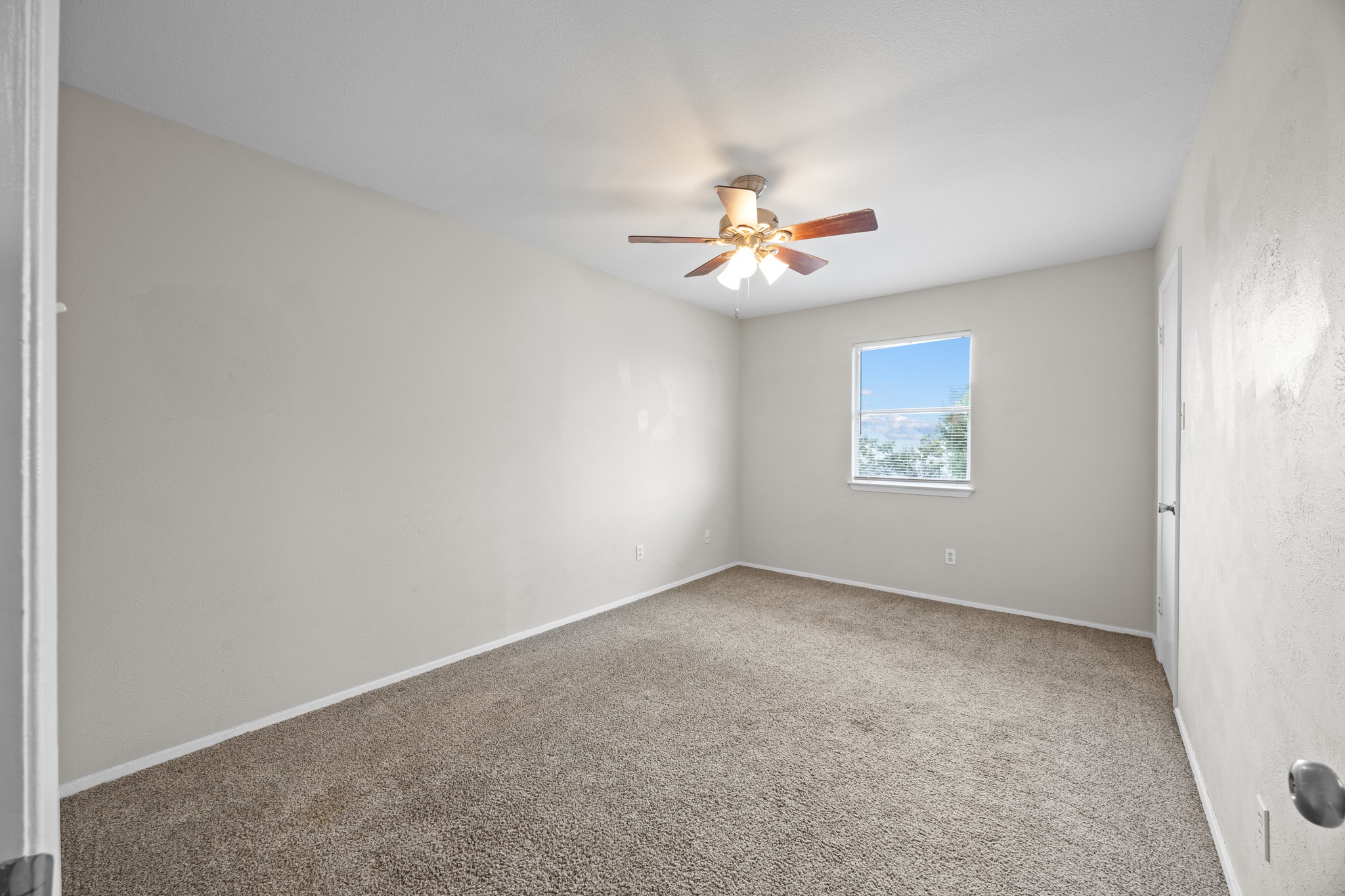 6904 Rifle Bend, Unit A Austin, TX 78736 - Photo 18 of 22 Unfurnished room featuring carpet flooring and a ceiling fan
