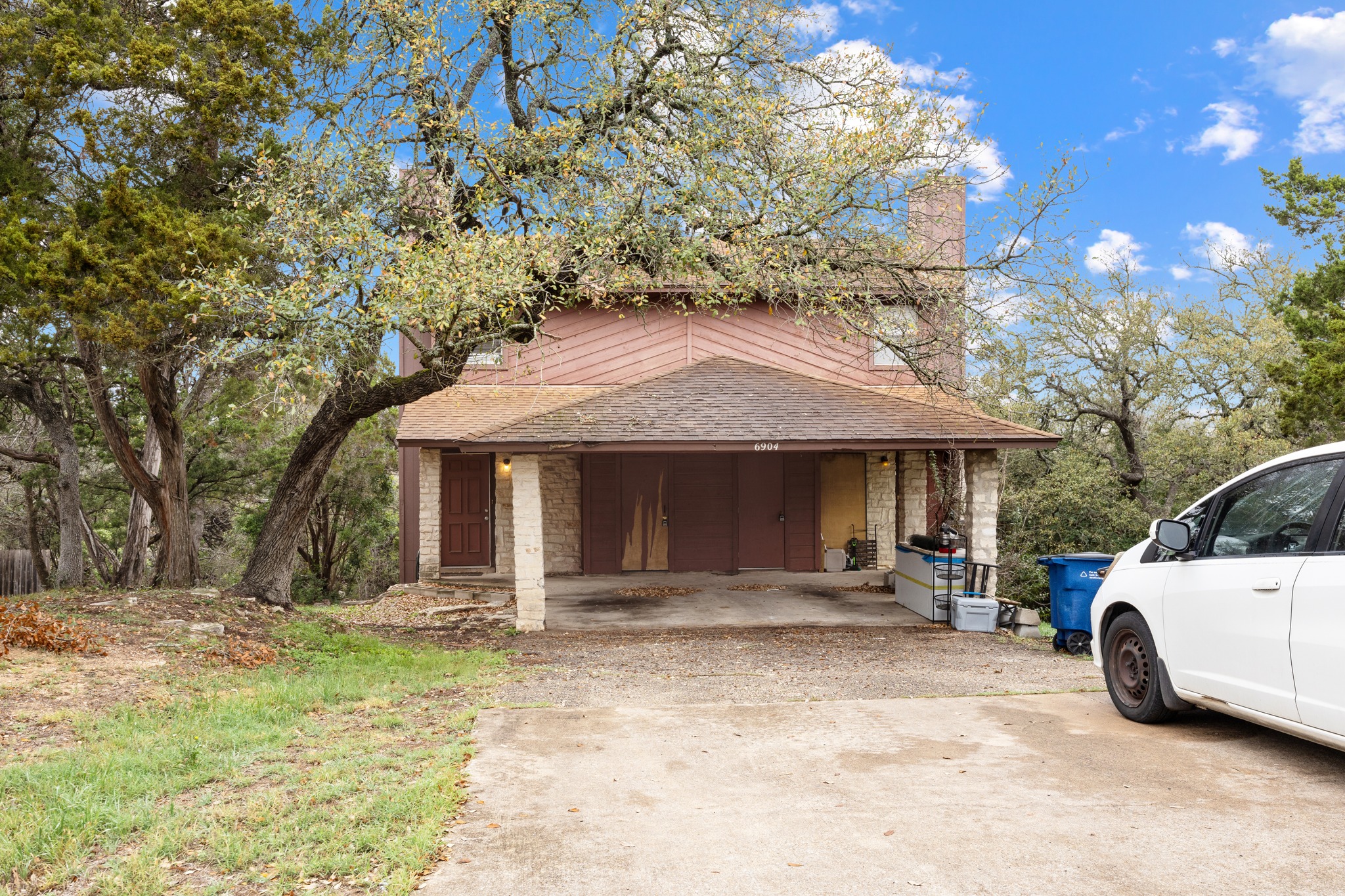 6904 Rifle Bend, Unit A Austin, TX 78736 - Photo 2 of 22 View of front of house featuring roof with shingles, a chimney, and driveway