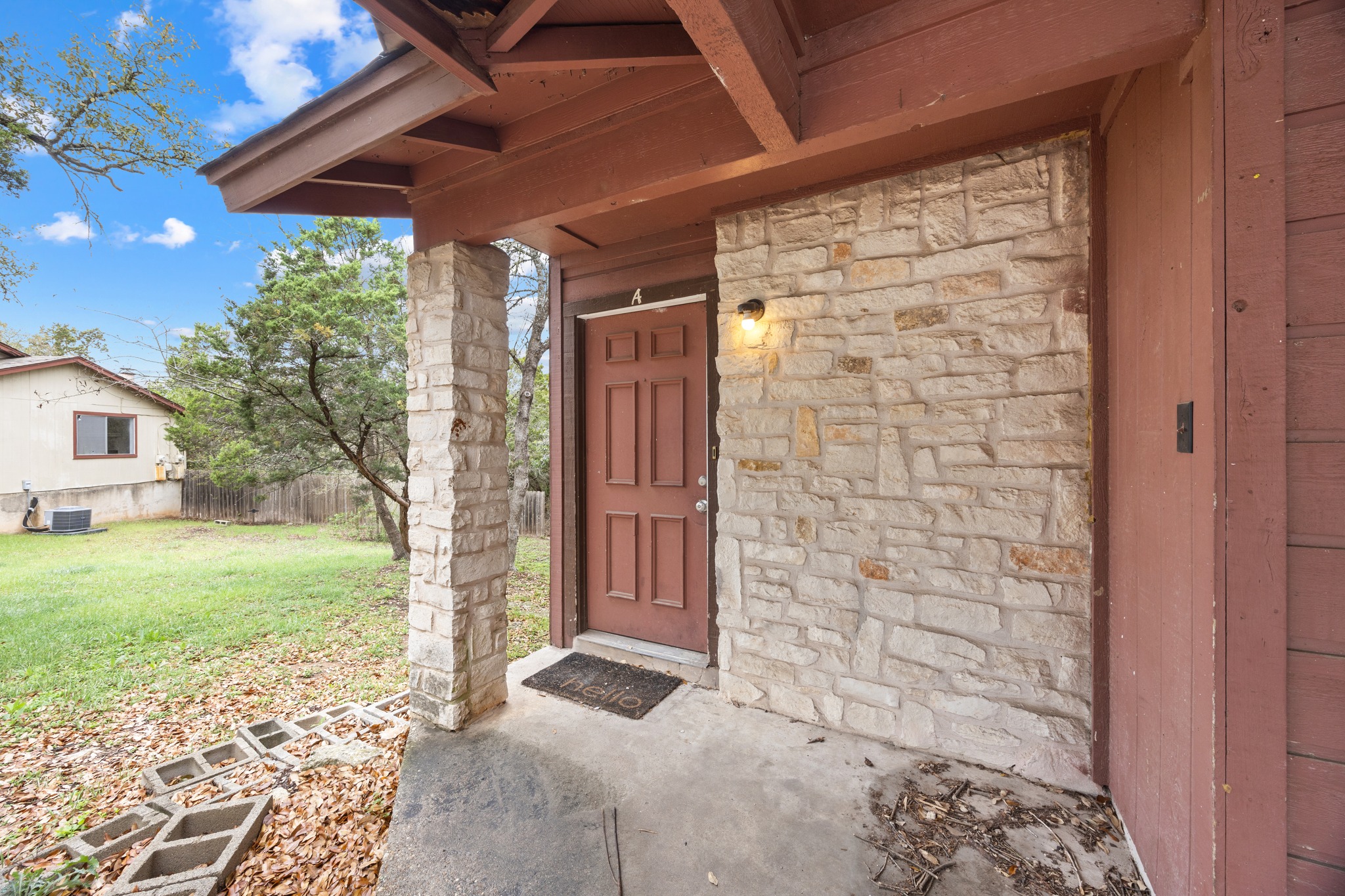 6904 Rifle Bend, Unit A Austin, TX 78736 - Photo 5 of 22 Entrance to property with stone siding