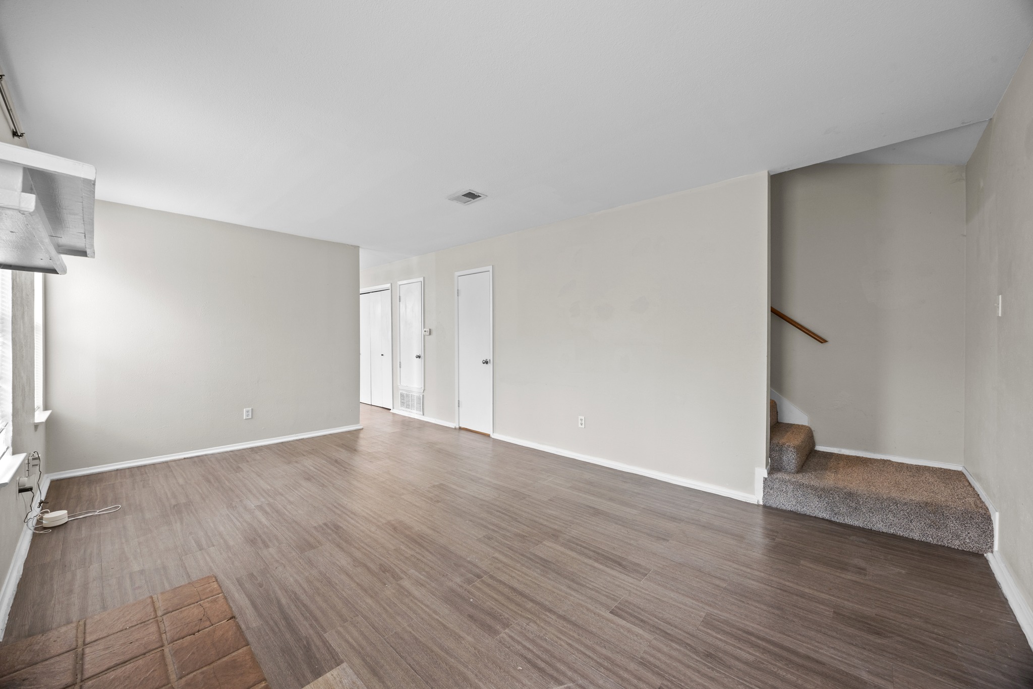 6904 Rifle Bend, Unit A Austin, TX 78736 - Photo 6 of 22 Unfurnished living room with dark wood-type flooring