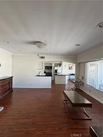 a living room with furniture a window and kitchen view