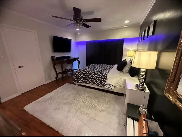 a bedroom with a bed window and a flat screen tv