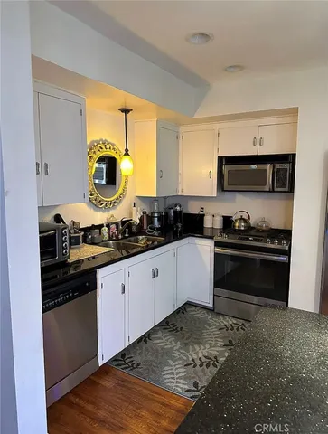 a kitchen with a sink a stove and cabinets