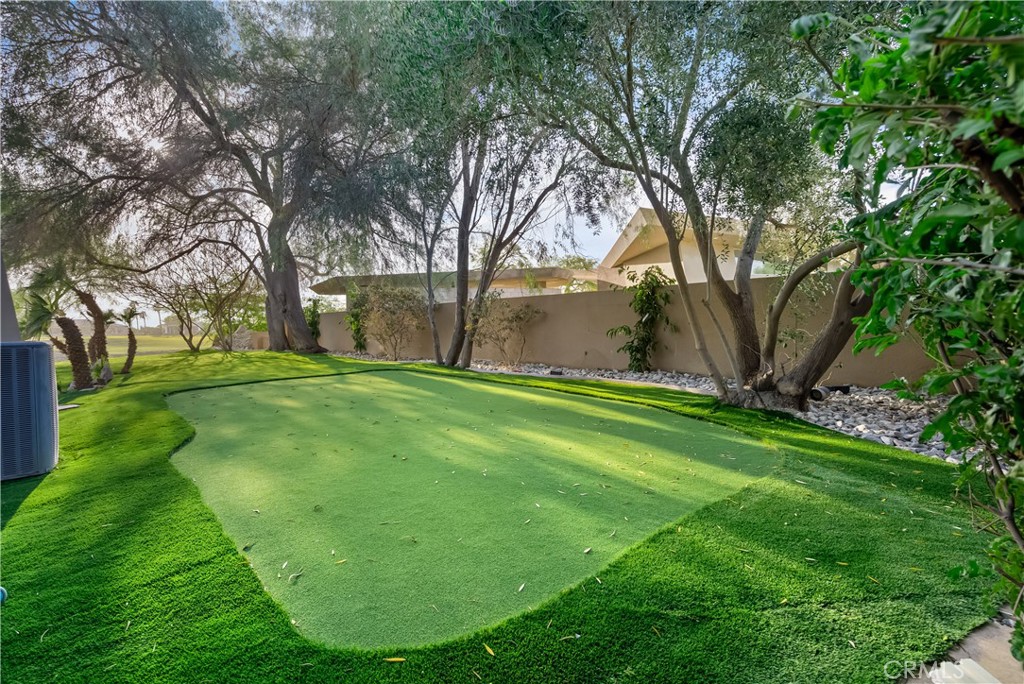 68 Royal St Georges Way Rancho Mirage, CA 92270 - Photo 18 of 75 a view of a backyard with large trees