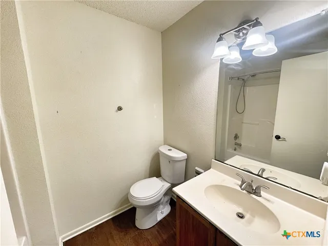 a bathroom with a sink mirror and toilet