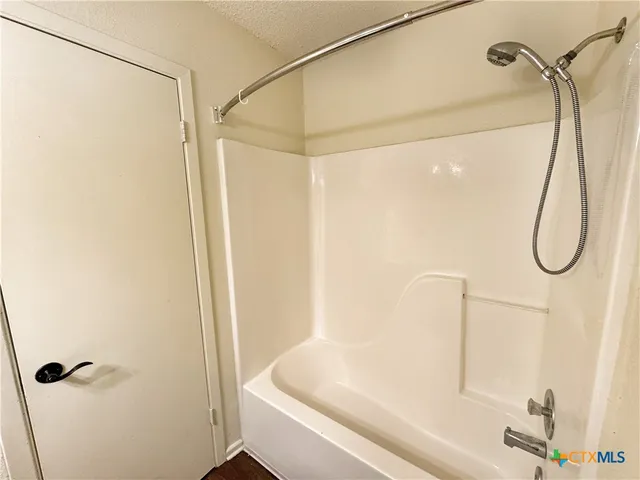 a bathroom with a shower and a shower