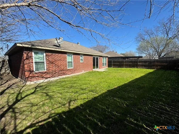 a view of a house with a backyard