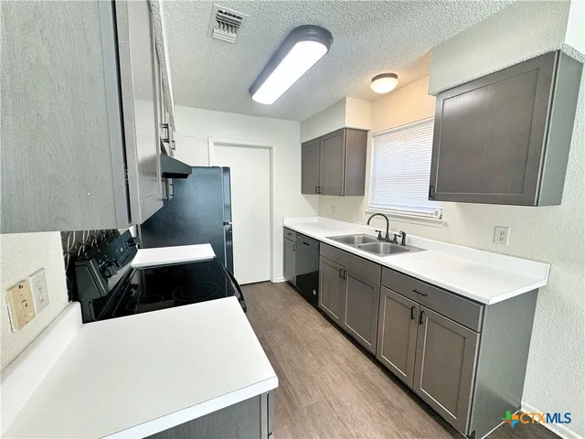 a spacious bathroom with a double vanity sink and a mirror