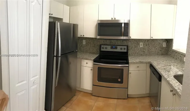 a kitchen with a refrigerator stove and microwave
