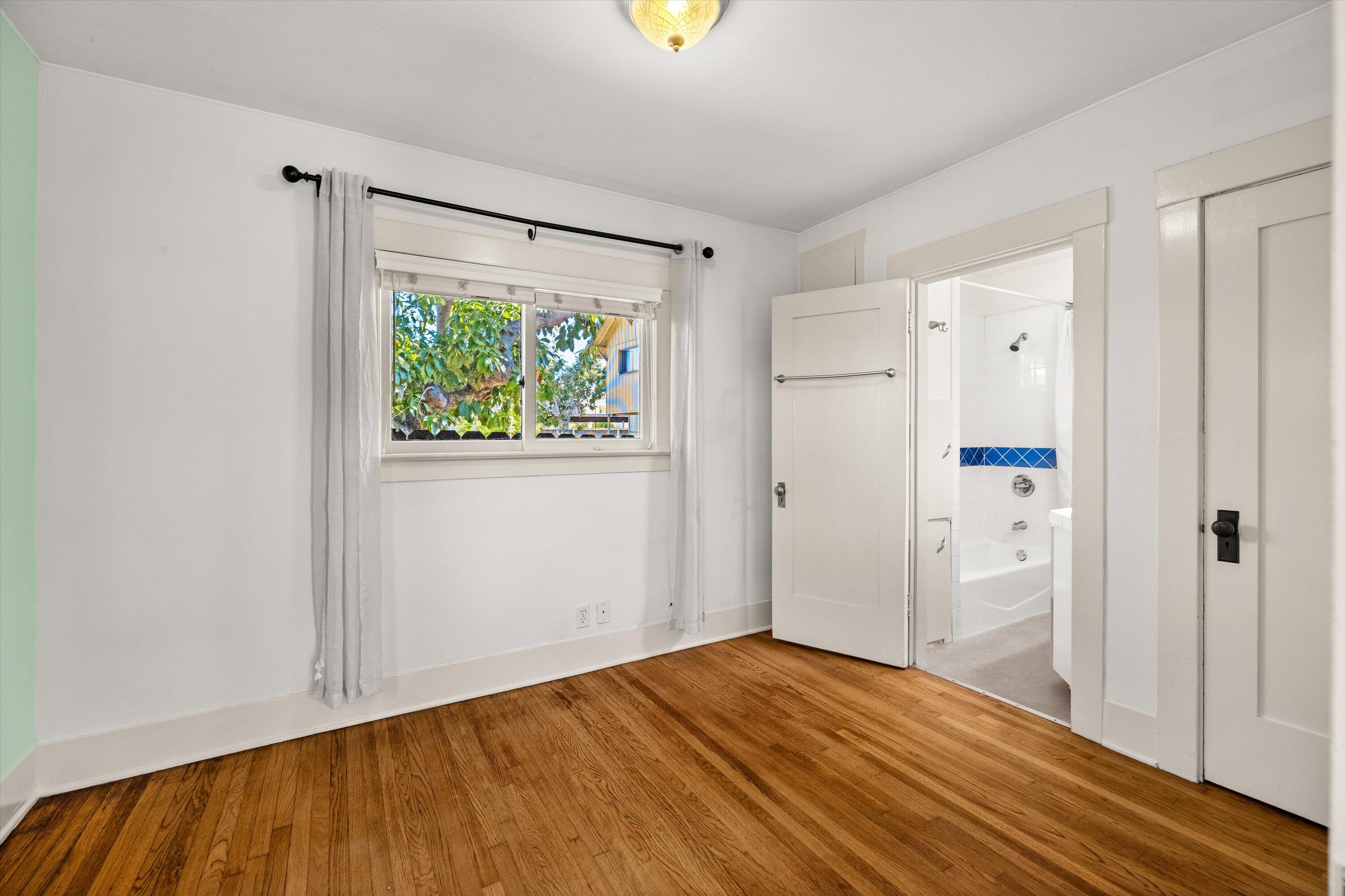 1620 De La Vina Street Santa Barbara, CA 93101 - Photo 18 of 46 a view of an empty room with wooden floor and a window