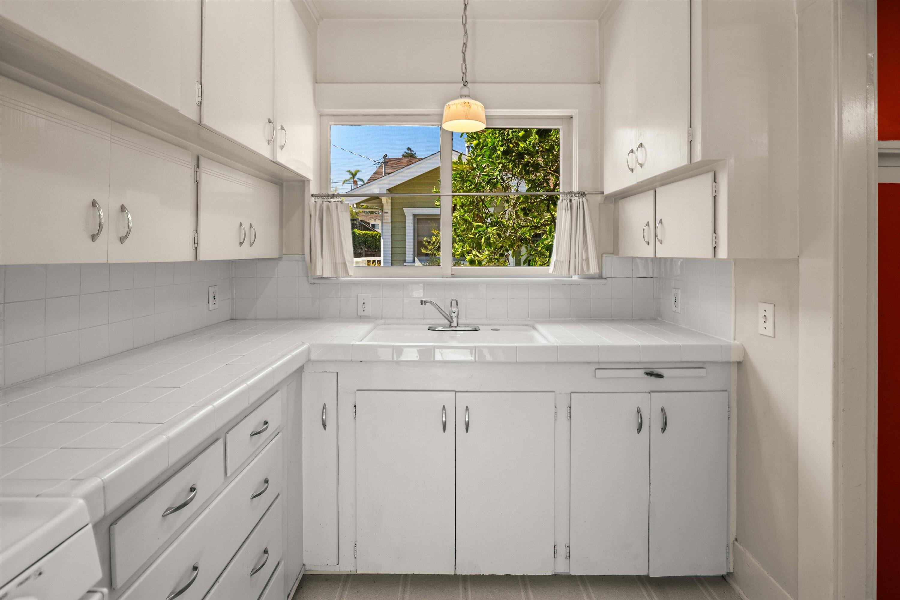 1620 De La Vina Street Santa Barbara, CA 93101 - Photo 31 of 46 a sink with cabinets and window