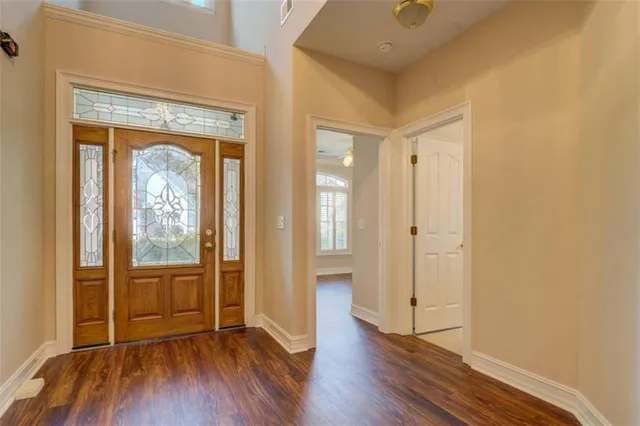 an empty room with wooden floor and a window